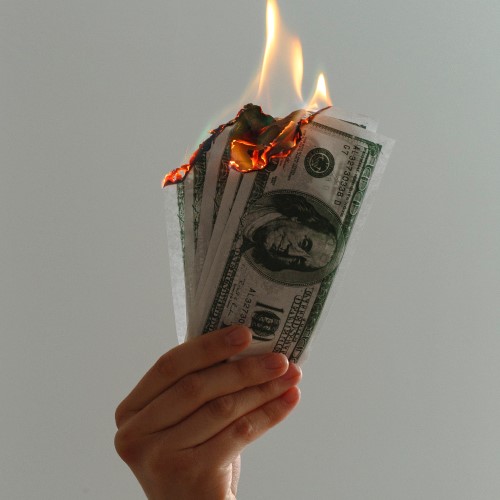 stack of 100 dollar bills burning